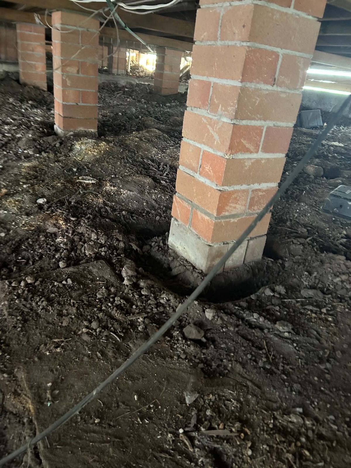 Subfloor piers trenched and treated